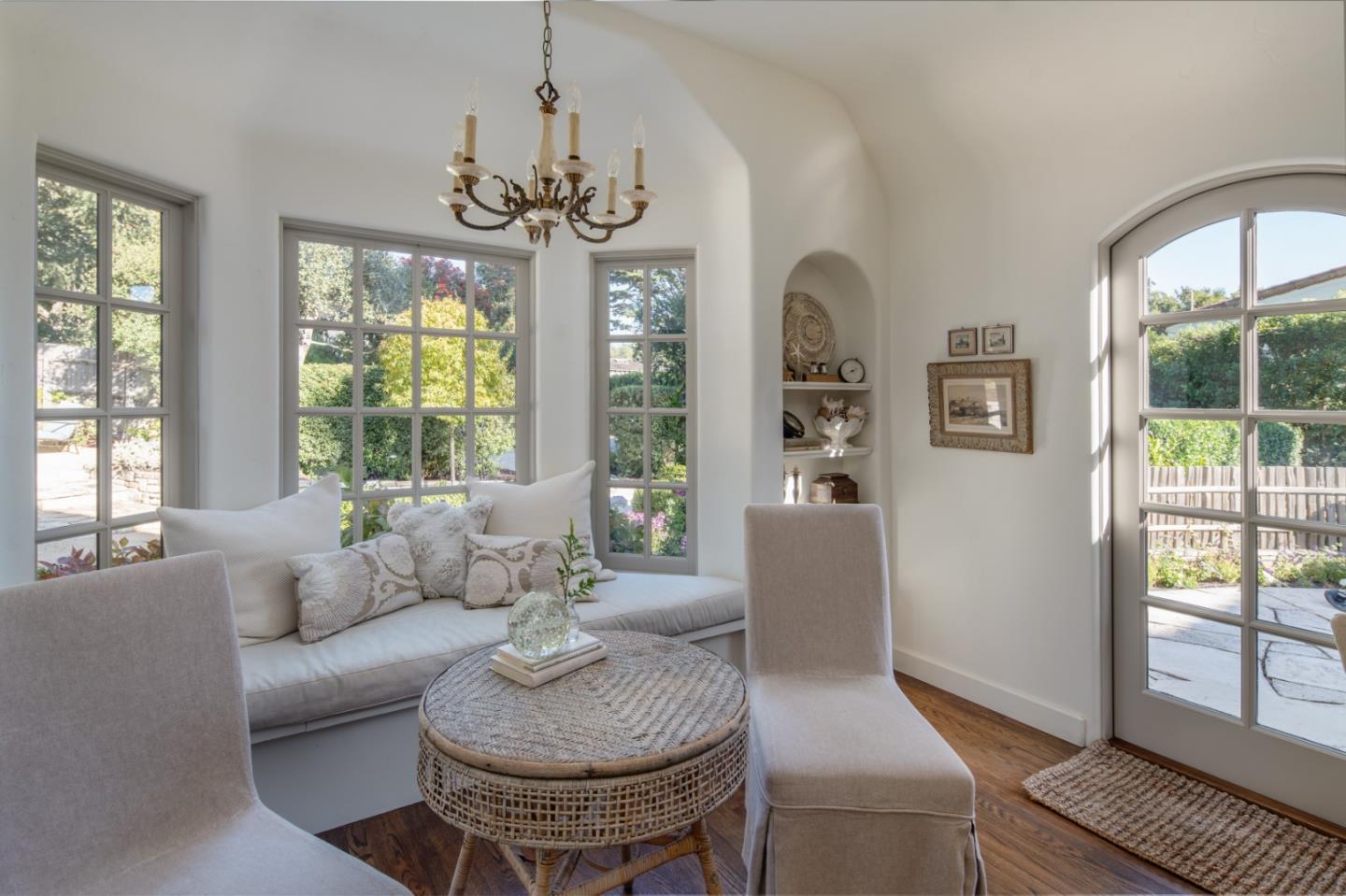 25148 Hatton Road Carmel, CA 93923 - Photo 8 of 33 a living room with furniture a chandelier and a large window