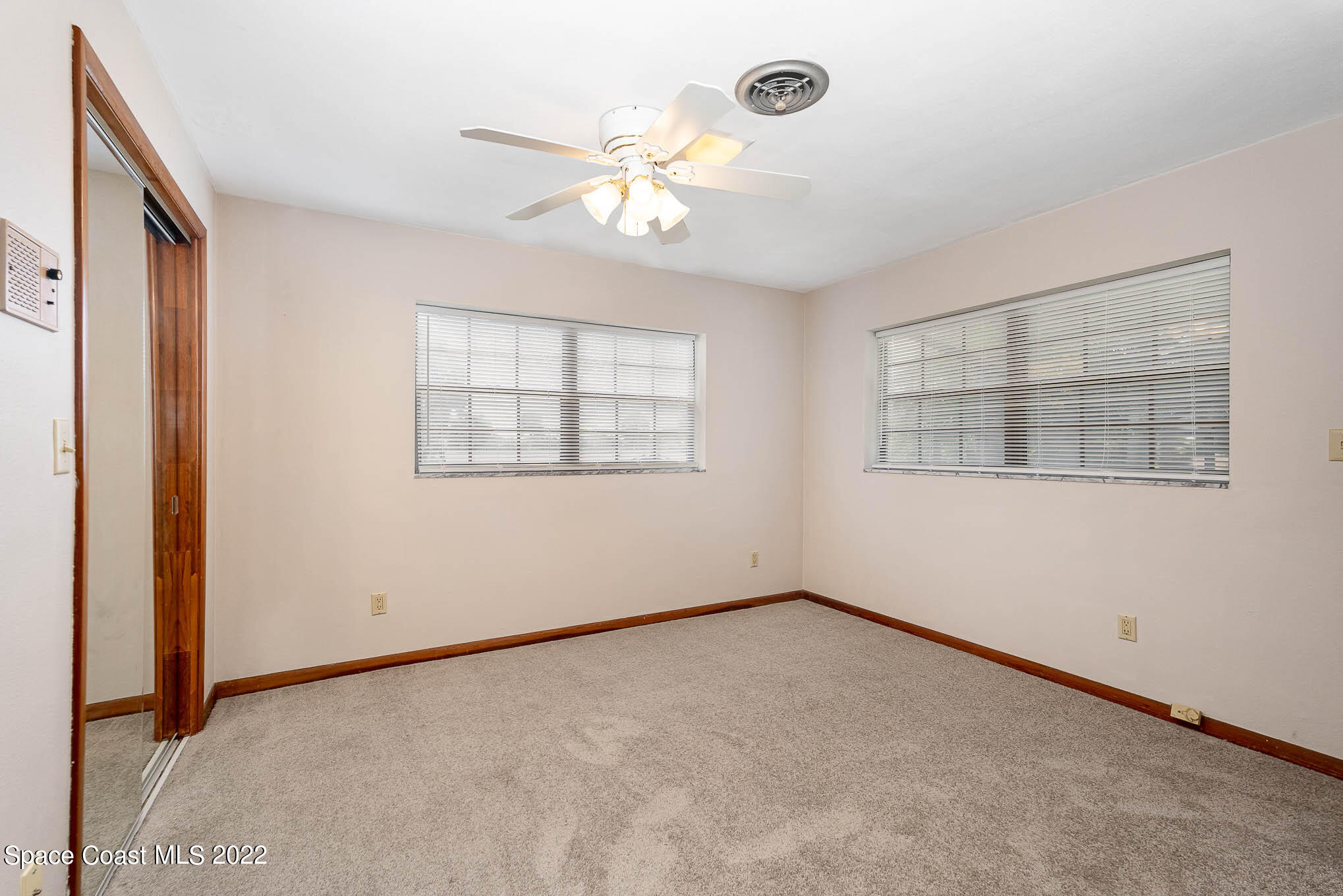 2676 Lemon Street Northeast Palm Bay, FL 32905 - Photo 18 of 35 an empty room with windows and fan