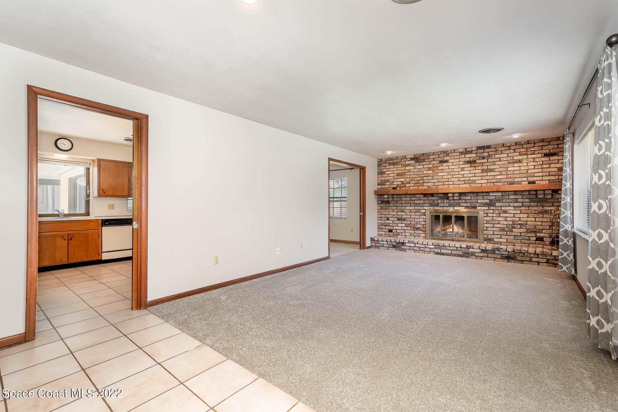 2676 Lemon Street Northeast Palm Bay, FL 32905 - Photo 2 of 35 a view of a livingroom with a fireplace and a large window