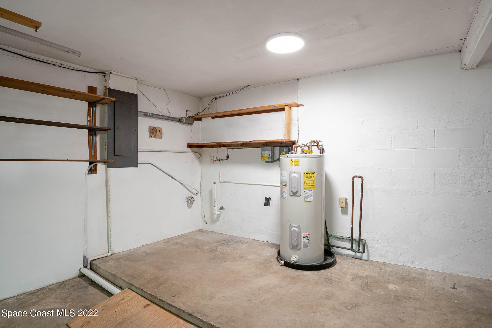 2676 Lemon Street Northeast Palm Bay, FL 32905 - Photo 27 of 35 a view of a room with water heater and refrigerator