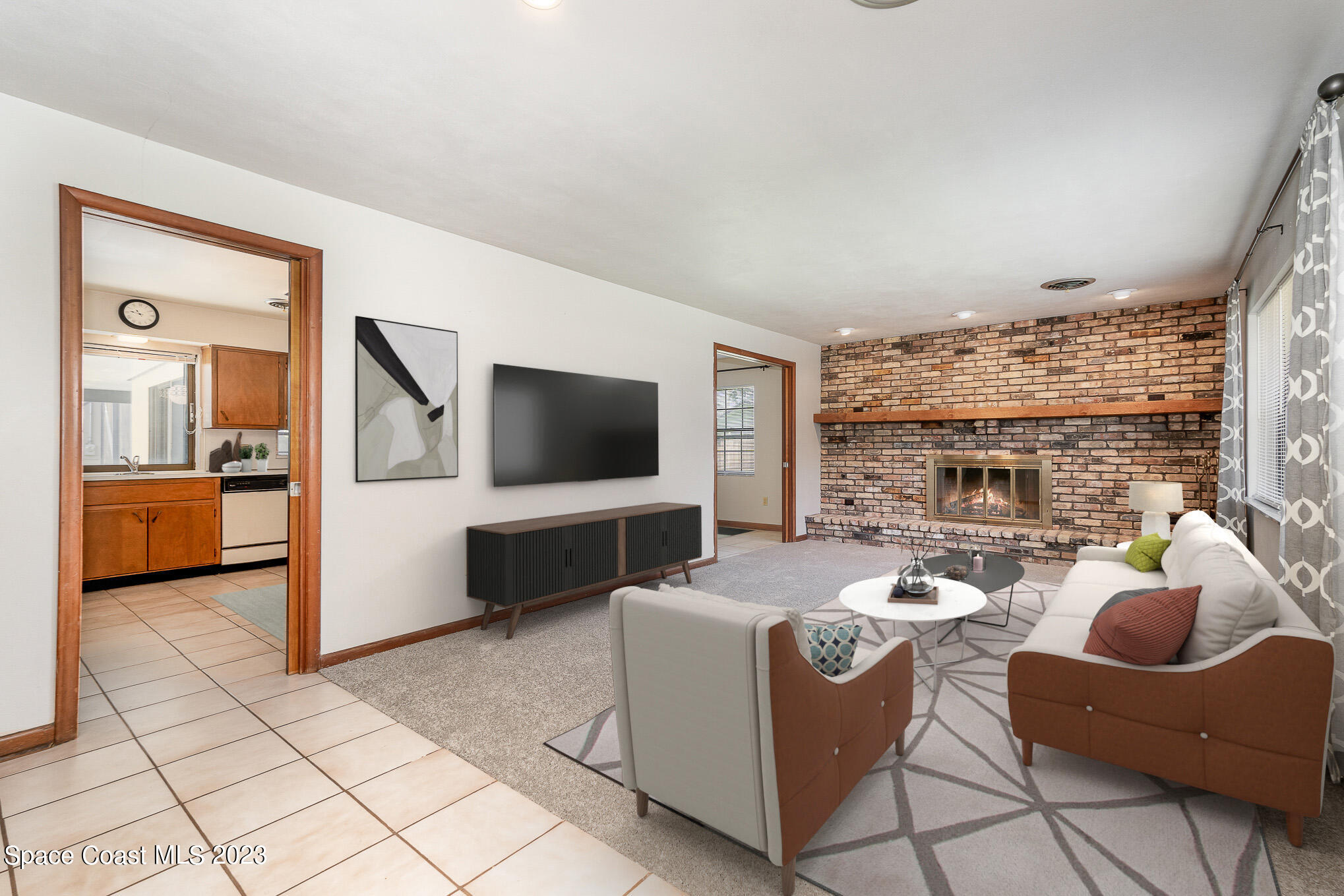 2676 Lemon Street Northeast Palm Bay, FL 32905 - Photo 4 of 35 a view of a livingroom with furniture and a flat screen tv