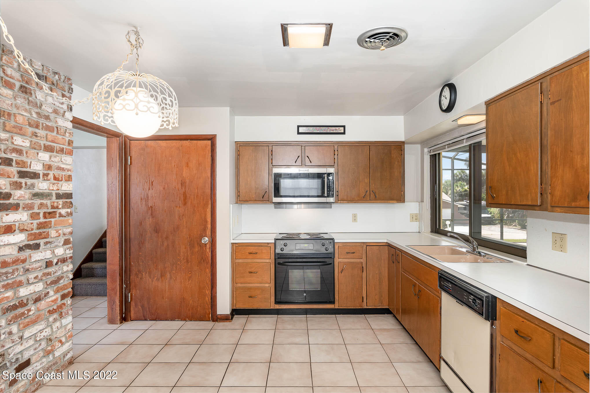 2676 Lemon Street Northeast Palm Bay, FL 32905 - Photo 5 of 35 a kitchen with stainless steel appliances a stove a sink and a refrigerator