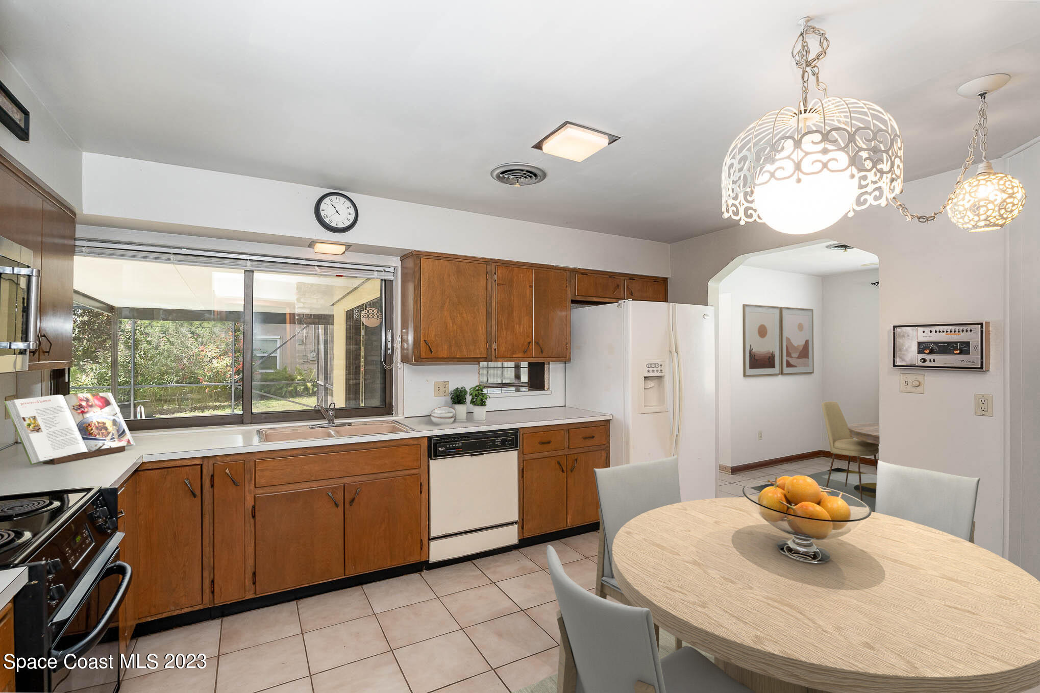 2676 Lemon Street Northeast Palm Bay, FL 32905 - Photo 8 of 35 a kitchen with granite countertop a sink a stove a dining table and chairs