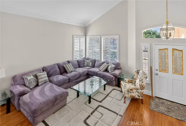a living room with a bed furniture and a large window