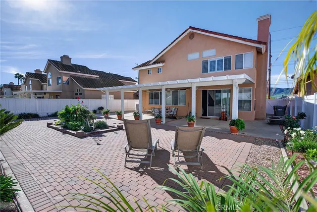 a view of a patio with a dining table and chairs