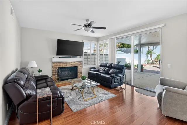 a living room with furniture wooden floor and windows