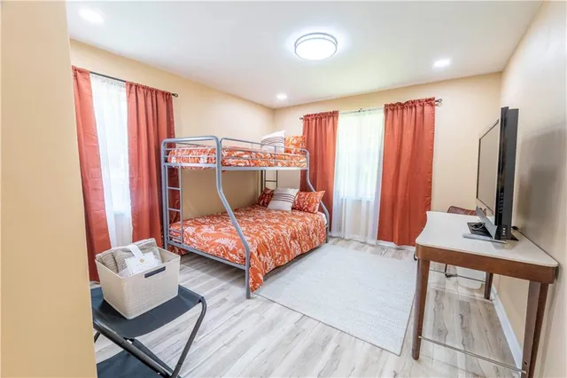 a bedroom with a large bed and a flat screen tv