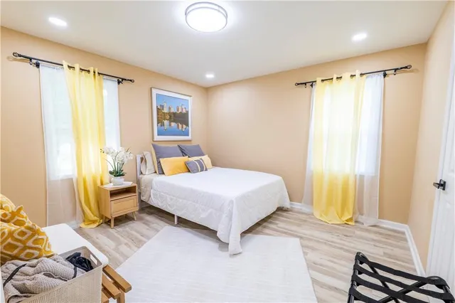 a bedroom with a bed and wooden floor