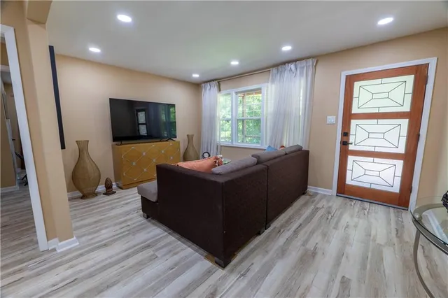 a living room with furniture and a flat screen tv