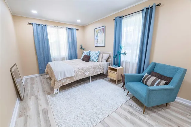 a bedroom with bed couch and window