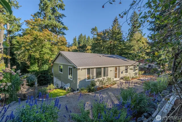 a view of a house with a yard and sitting area
