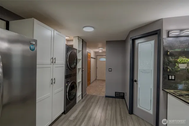 a kitchen with a refrigerator and a stove top oven