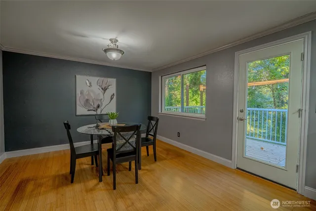 a dining room with furniture and wooden floor