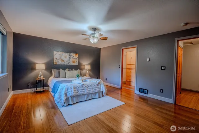 a bedroom with a bed and wooden floor