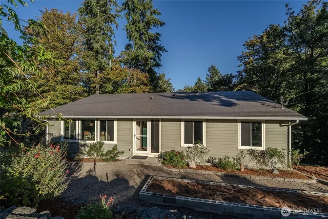 a front view of a house with yard and green space