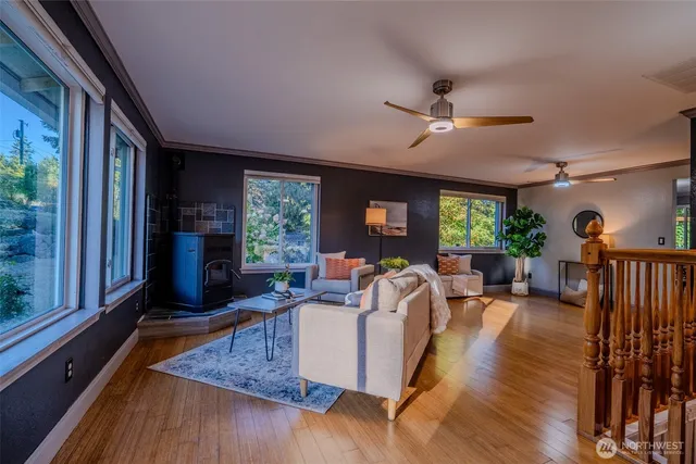 a living room with furniture fireplace and large windows
