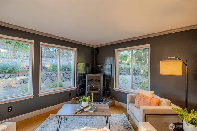 a living room with fireplace furniture and a large window