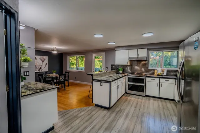 a kitchen with counter top space a sink and appliances