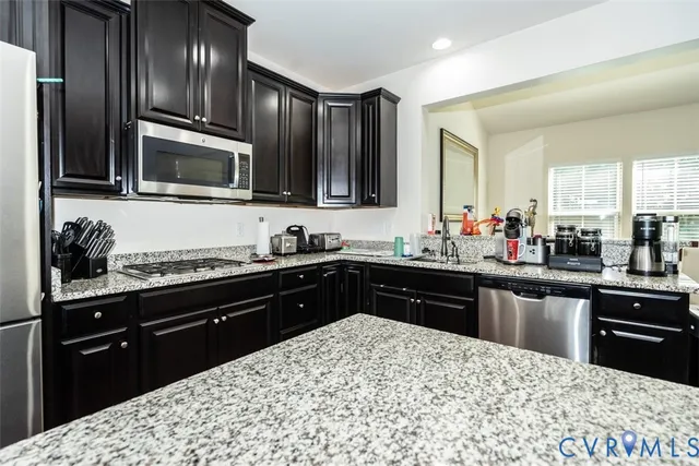 a kitchen with a sink stove and refrigerator