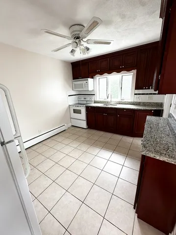 a kitchen with stainless steel appliances kitchen island granite countertop a sink and cabinets