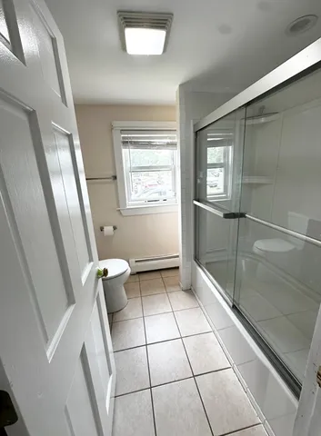 a bathroom with a toilet a sink and shower