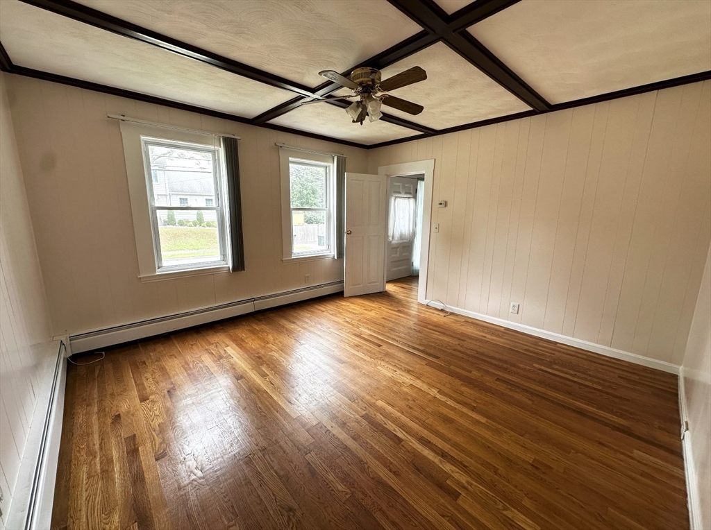 18 Boston Street, Unit RIGHT SIDE Middleton, MA 01949 - Photo 4 of 7 an empty room with wooden floor and windows