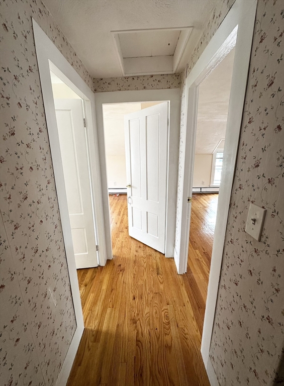 18 Boston Street, Unit RIGHT SIDE Middleton, MA 01949 - Photo 5 of 7 a view of a hallway with wooden floor and staircase