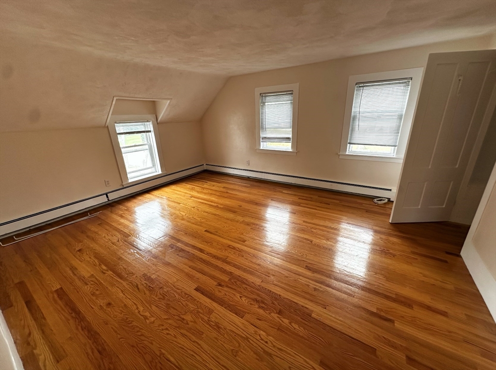 18 Boston Street, Unit RIGHT SIDE Middleton, MA 01949 - Photo 7 of 7 a view of empty room with wooden floor and fan