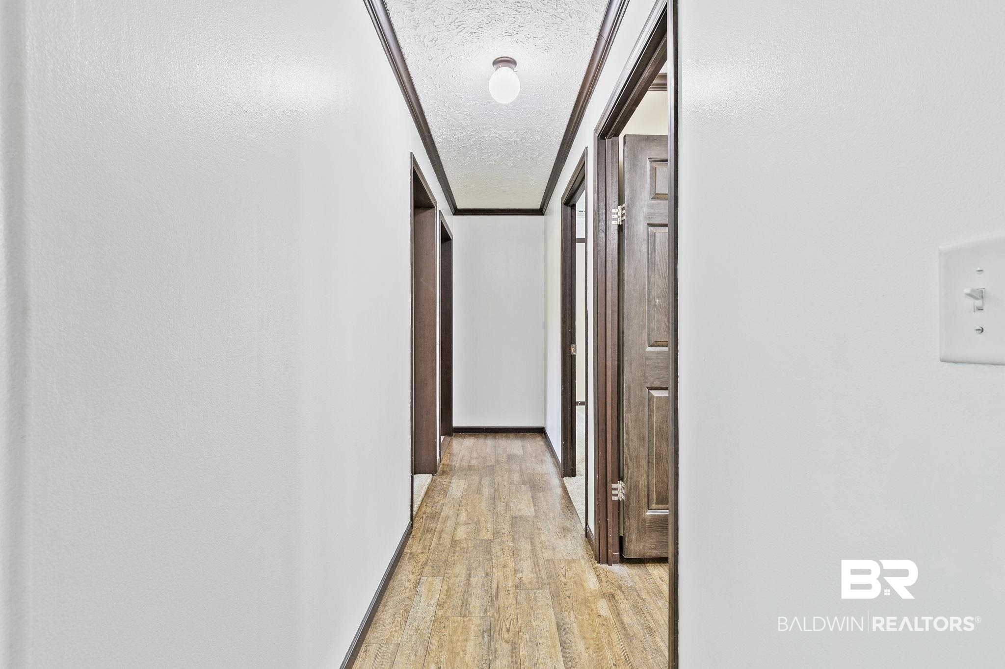 35641 County Road 39 Stapleton, AL 36578 - Photo 22 of 46 Hall with a textured ceiling and light wood-type flooring