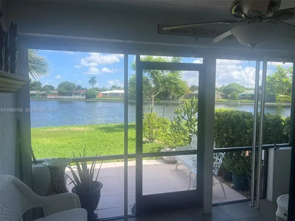 a view of a chairs and table in patio