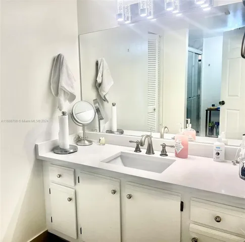 a bathroom with a double vanity sink and a mirror