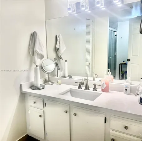 a bathroom with a double vanity sink and a mirror