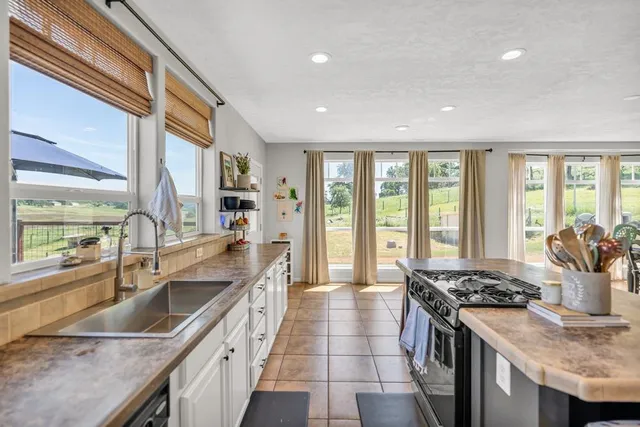 a kitchen with a table chairs stove and cabinets