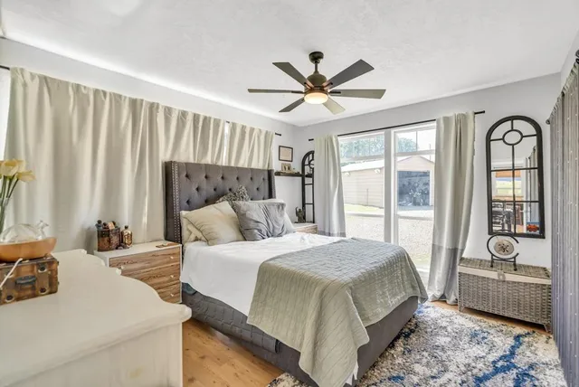 a spacious bedroom with a bed and a large window