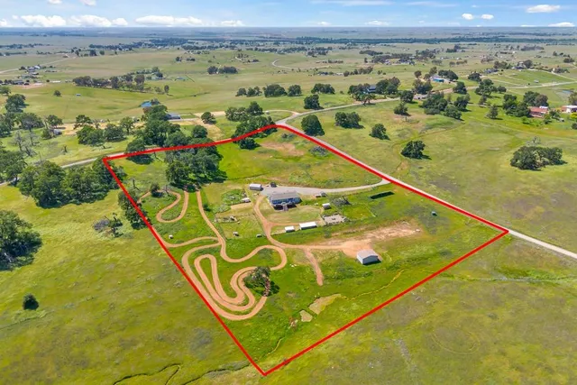 a front view of house with yard outdoor seating and barbeque oven