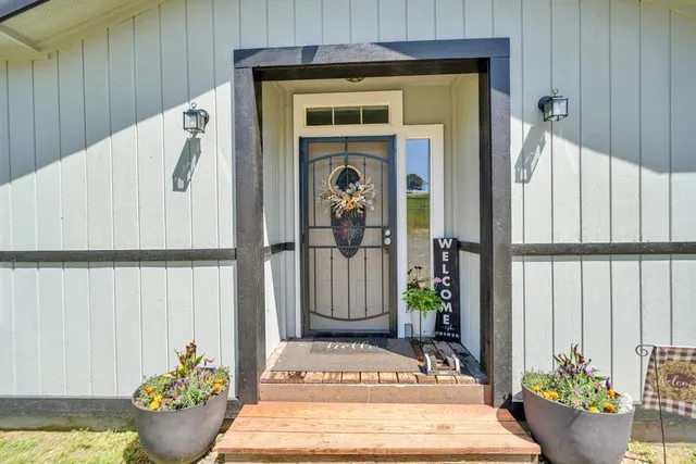 an outdoor sitting area with furniture and umbrella