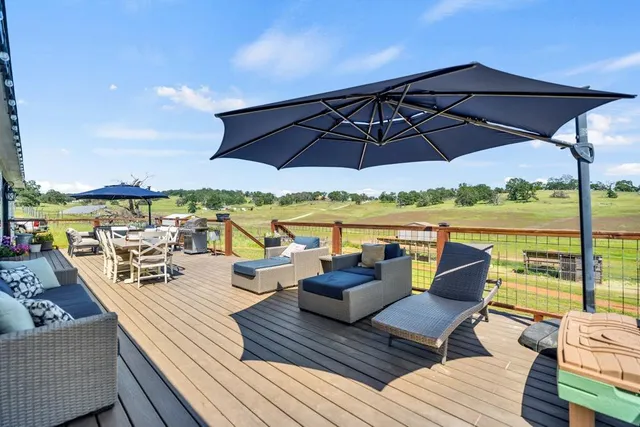 a front view of a house with a yard and potted plants
