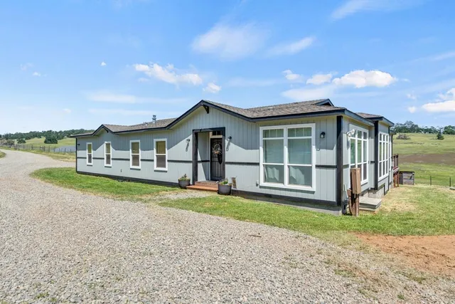 a dining room with furniture window and wooden floor