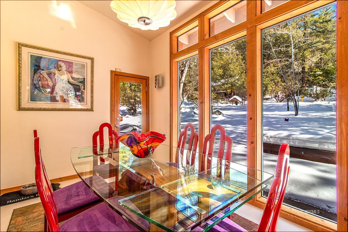 25440 Seneca Road Idyllwild, CA 92549 - Photo 15 of 68 a view of a dining room with furniture one side kitchen view and wooden floor