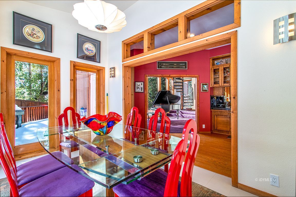25440 Seneca Road Idyllwild, CA 92549 - Photo 17 of 68 a view of a dining room with furniture a chandelier and wooden floor