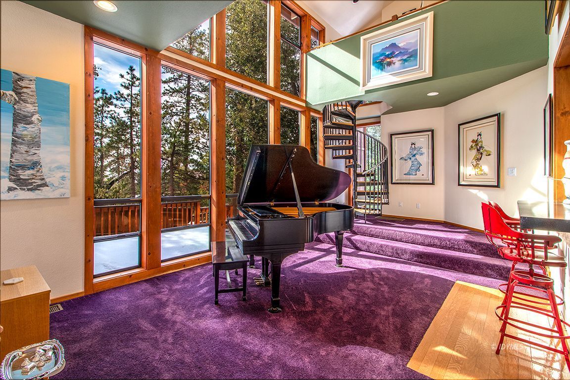 25440 Seneca Road Idyllwild, CA 92549 - Photo 20 of 68 a living room with furniture rug and a floor to ceiling window