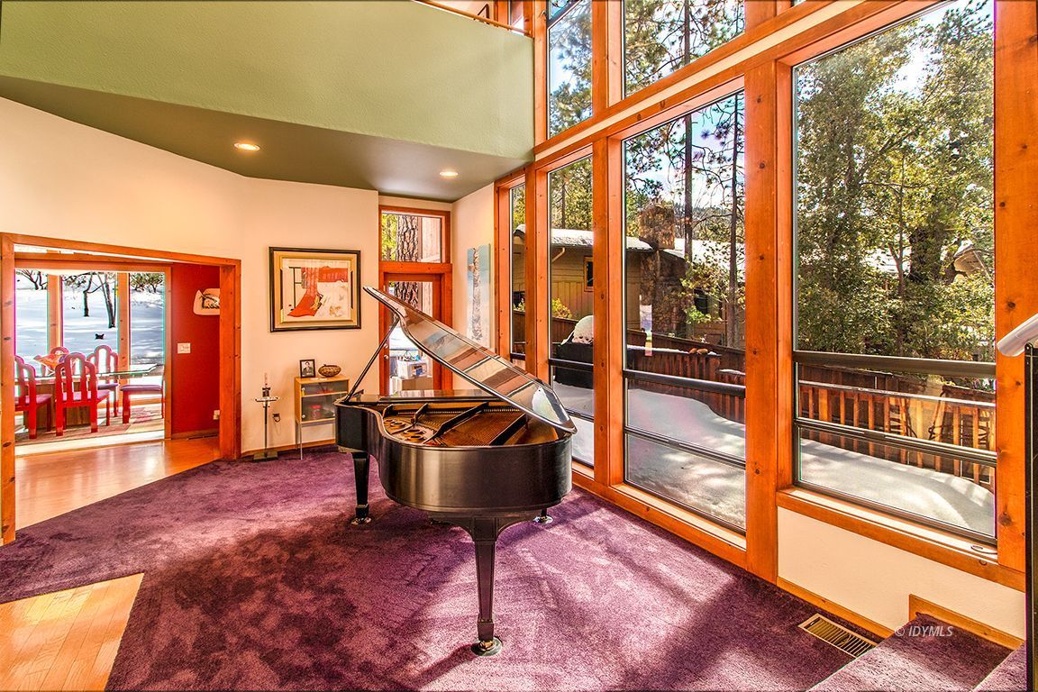 25440 Seneca Road Idyllwild, CA 92549 - Photo 21 of 68 a view of an empty room with wooden floor and windows