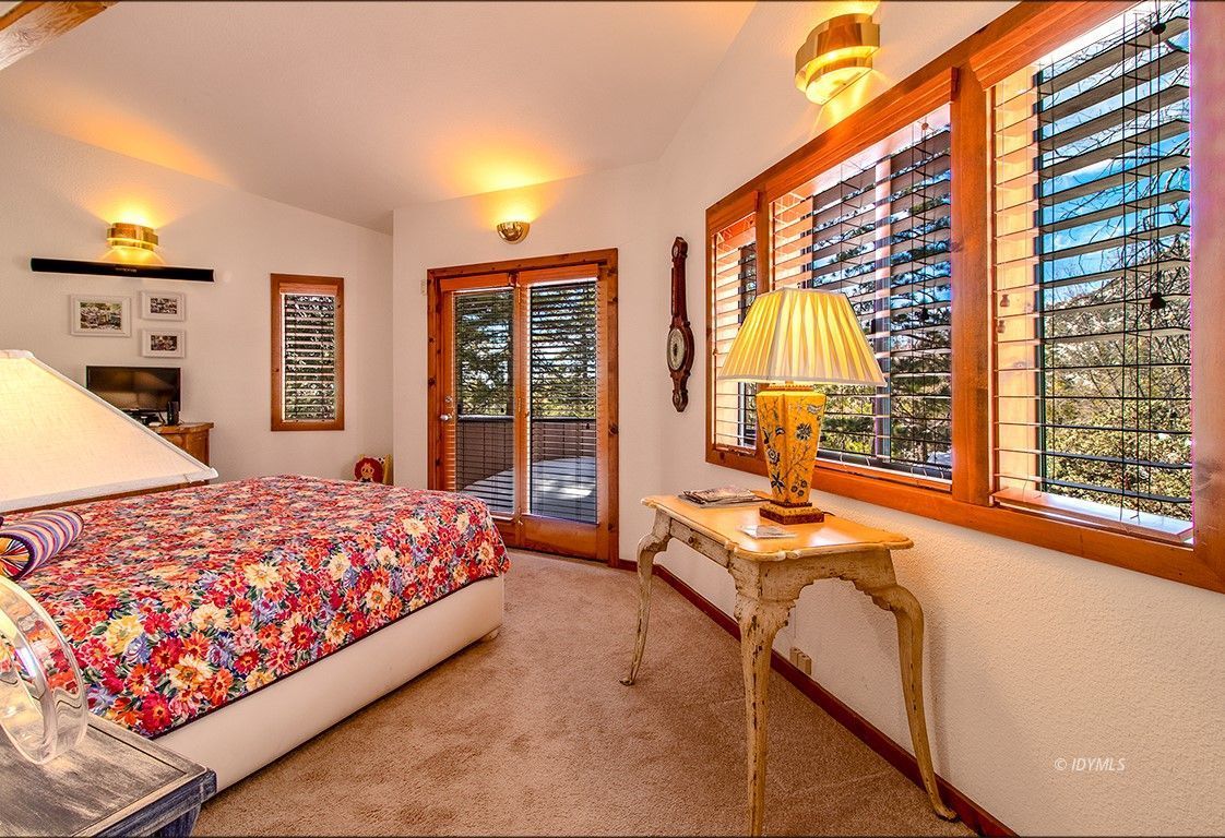 25440 Seneca Road Idyllwild, CA 92549 - Photo 31 of 68 a bedroom with a bed and large windows