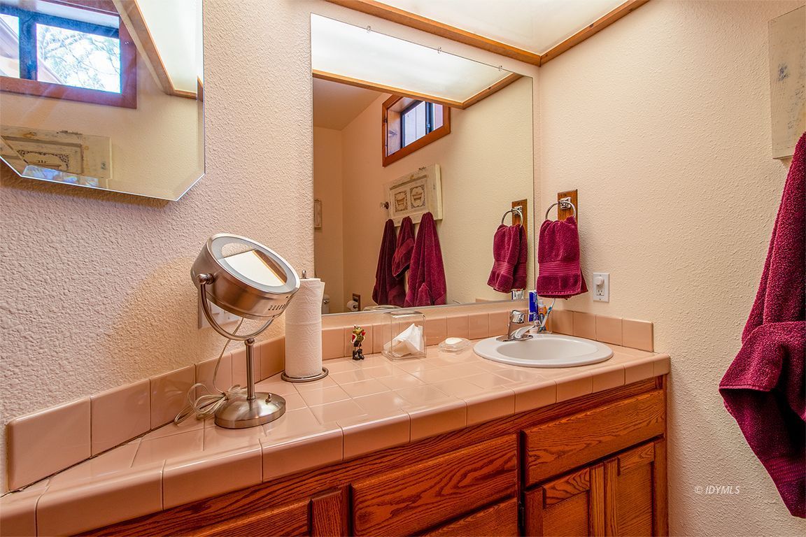 25440 Seneca Road Idyllwild, CA 92549 - Photo 35 of 68 a bathroom with a sink and a mirror