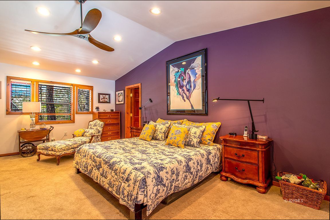 25440 Seneca Road Idyllwild, CA 92549 - Photo 37 of 68 a bedroom with a bed gym equipment and a large window