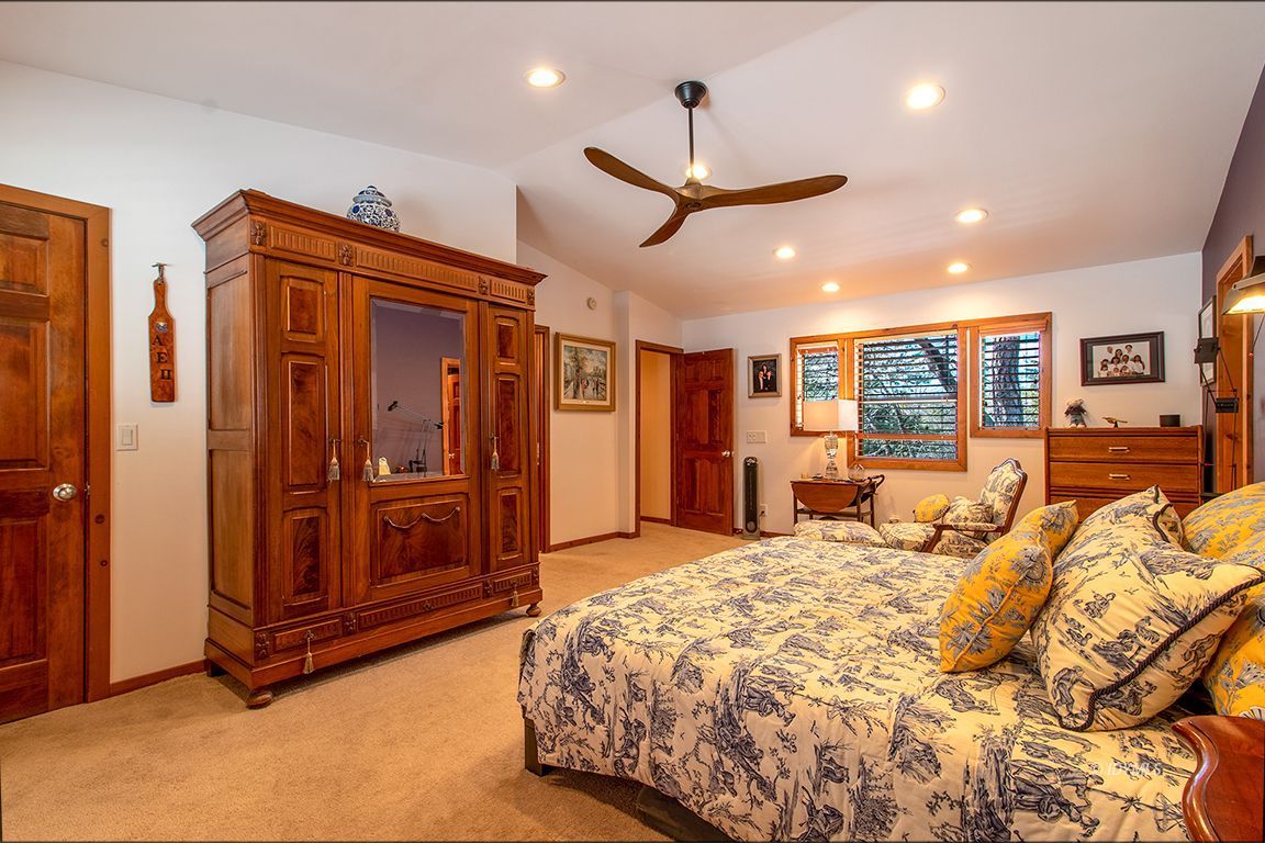 25440 Seneca Road Idyllwild, CA 92549 - Photo 39 of 68 a spacious bedroom with a bed and ceiling fan