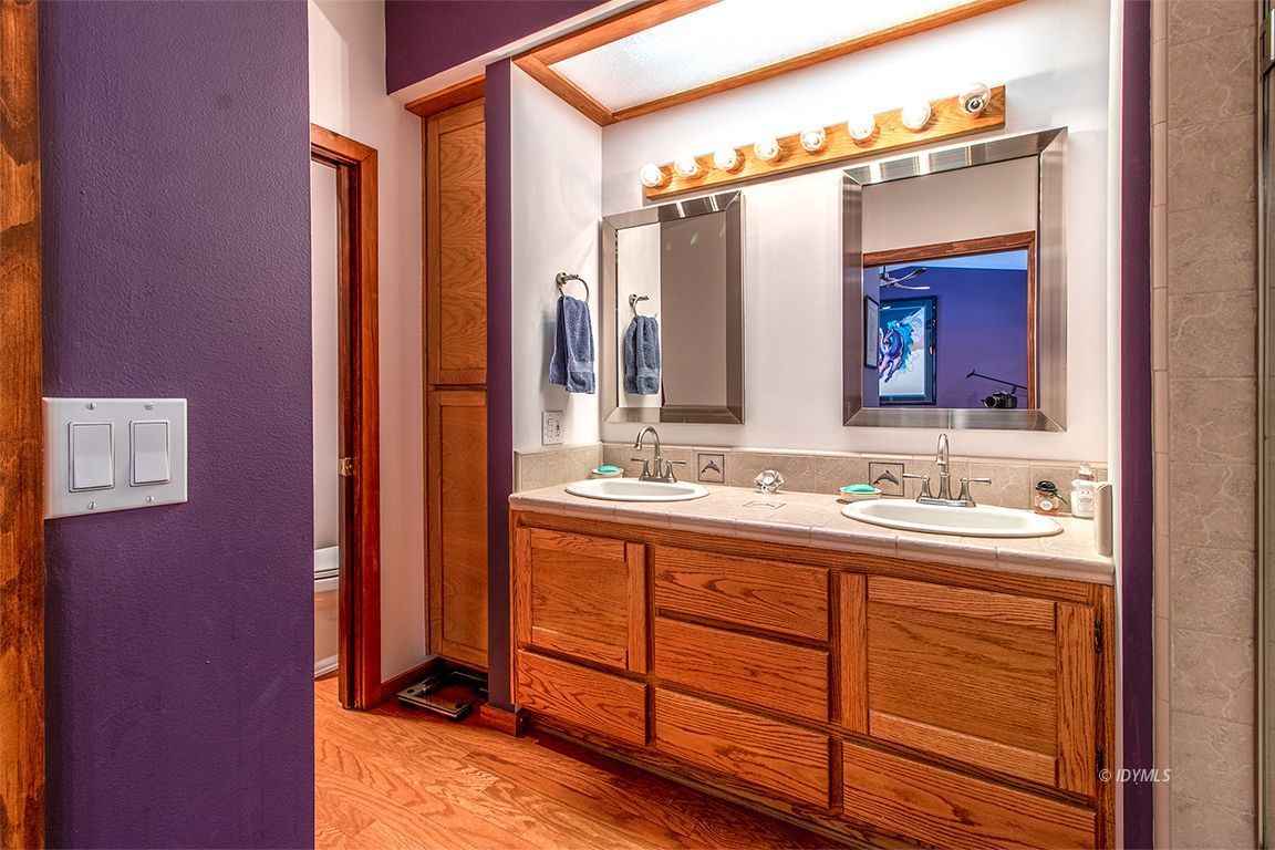 25440 Seneca Road Idyllwild, CA 92549 - Photo 40 of 68 a bathroom with a double vanity sink and mirror