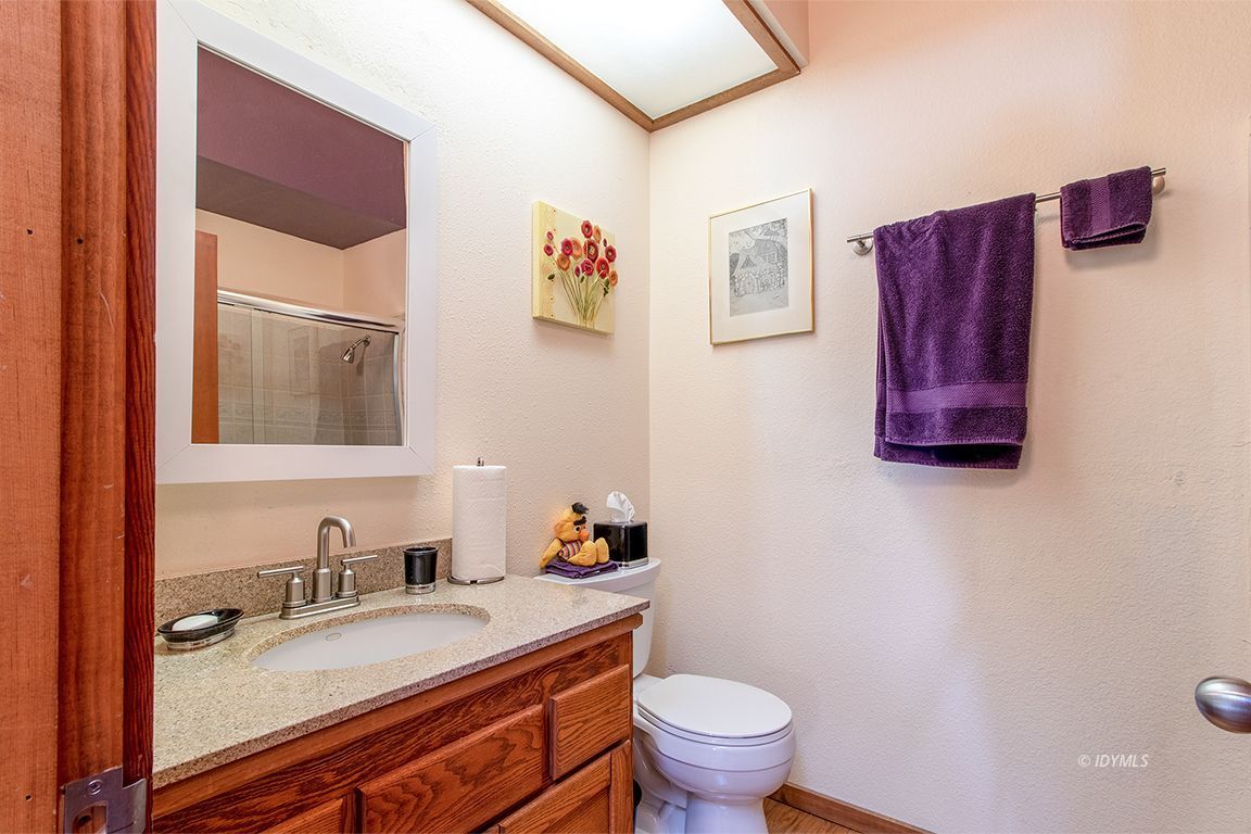 25440 Seneca Road Idyllwild, CA 92549 - Photo 52 of 68 a bathroom with a granite countertop sink and a mirror