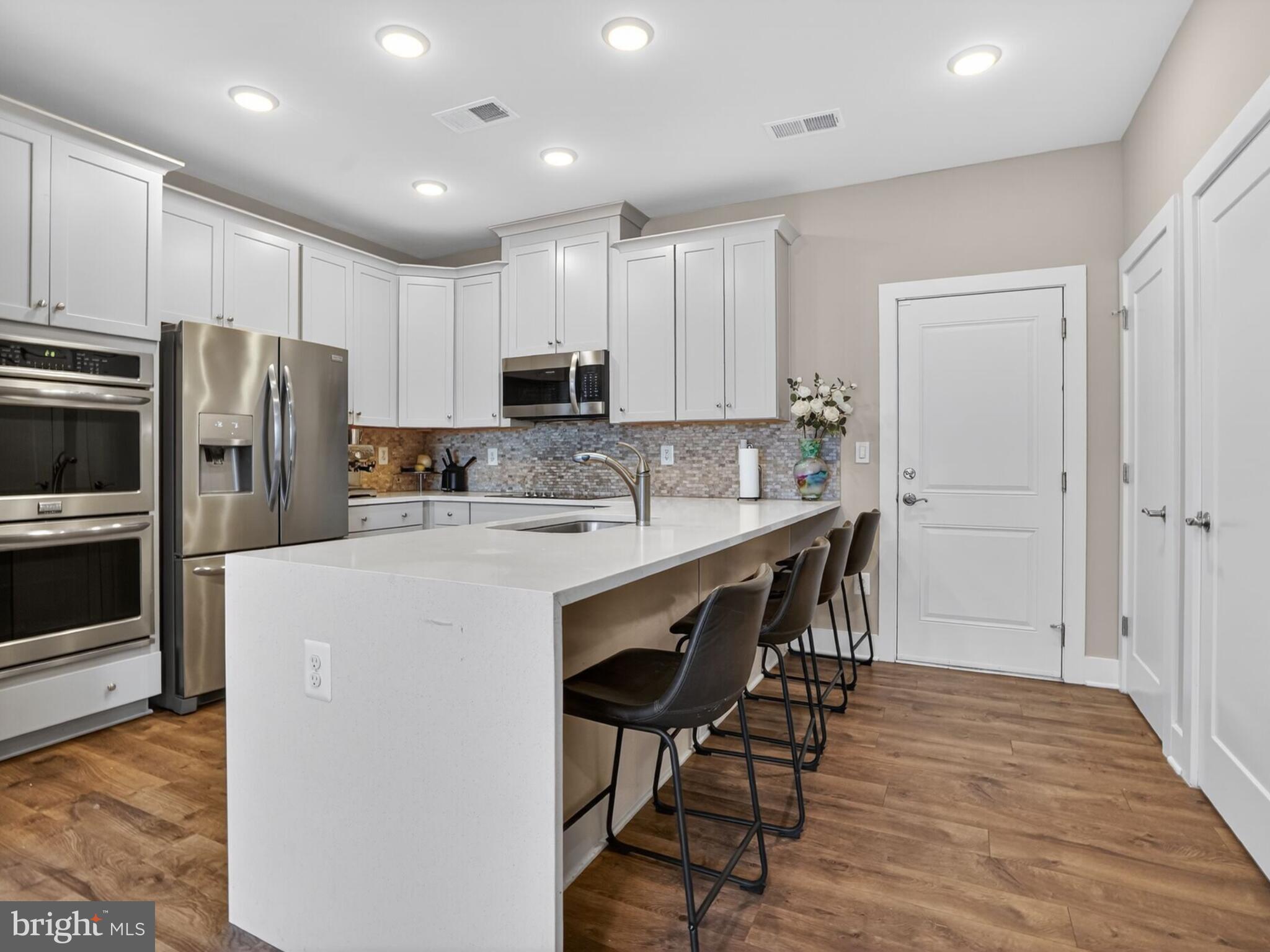 55 Silverway Drive, Unit 48 Herndon, VA 20170 - Photo 11 of 31 Seating for 4 at the Kitchen Bar