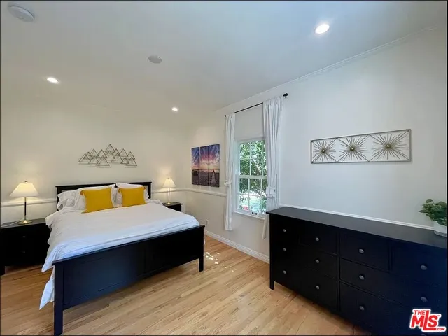 a bedroom with a bed and a night stand